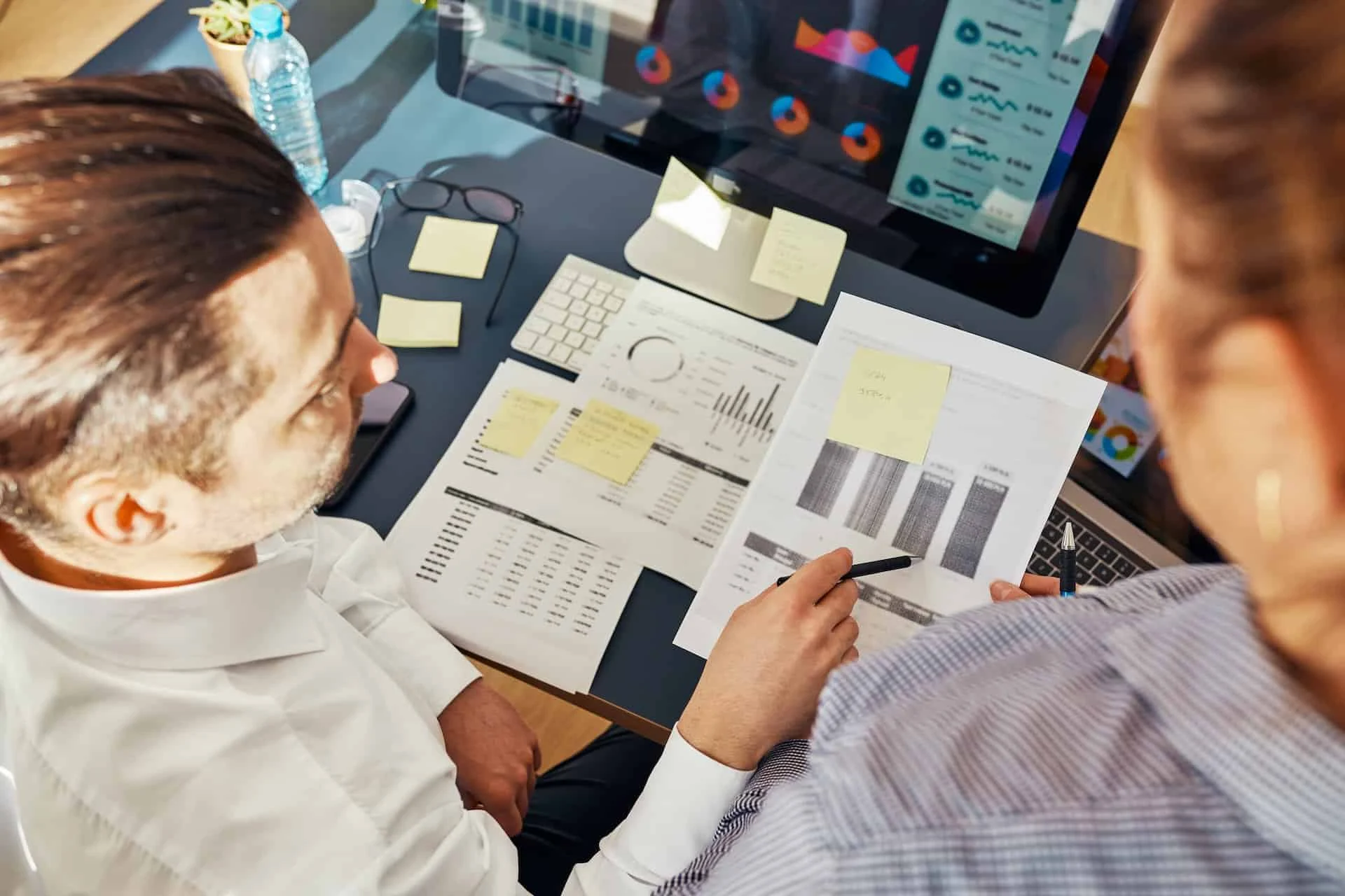 Colleagues analysing business performance metrics.